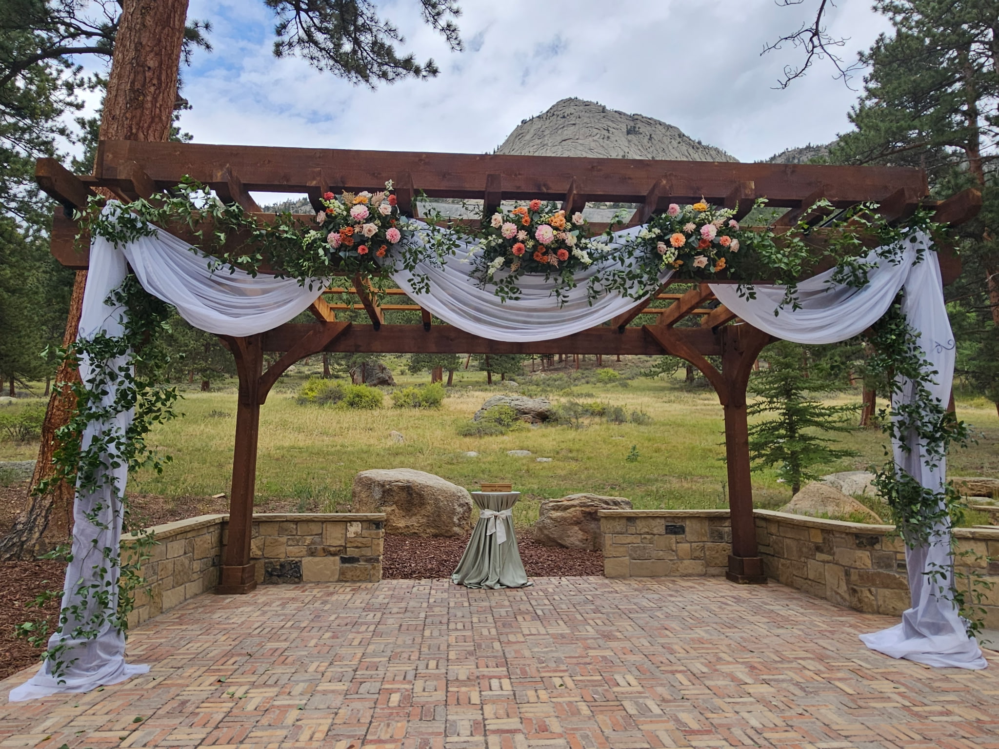 Outdoor wedding pergola with white fabric draping at Della Terra Mountain Chateau