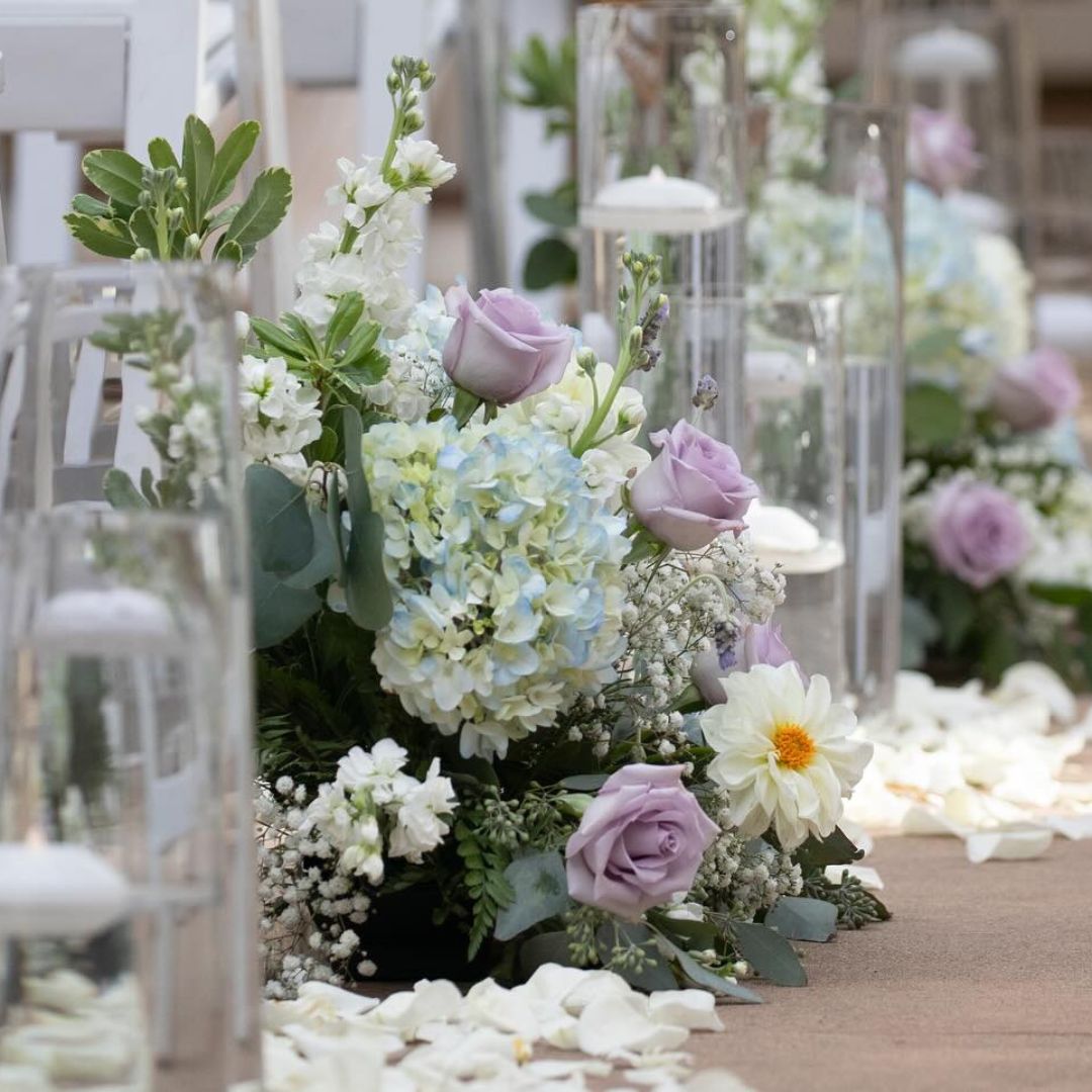 Wedding ceremony aisle florals with lavender roses, blue hydrangea, dahlias and rose petals — The Joyful Poppy Fort Collins CO